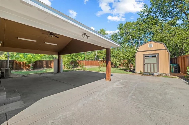 a view of a house with a backyard and a garage