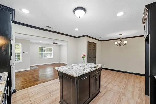 a kitchen with granite countertop sink stove and refrigerator