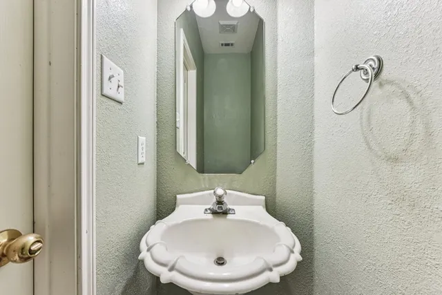a kitchen with sink a microwave and cabinets
