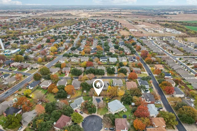 an aerial view of residential house with outdoor space and swimming pool