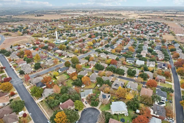 an aerial view of residential houses with outdoor space
