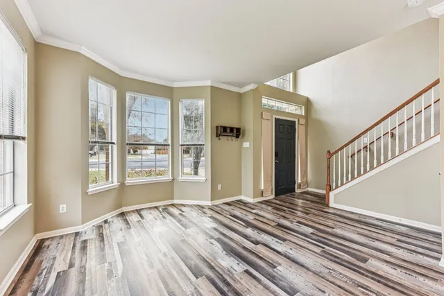 a view of a bedroom with wooden floor