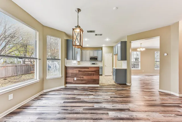 a view of kitchen and hall with wooden floor