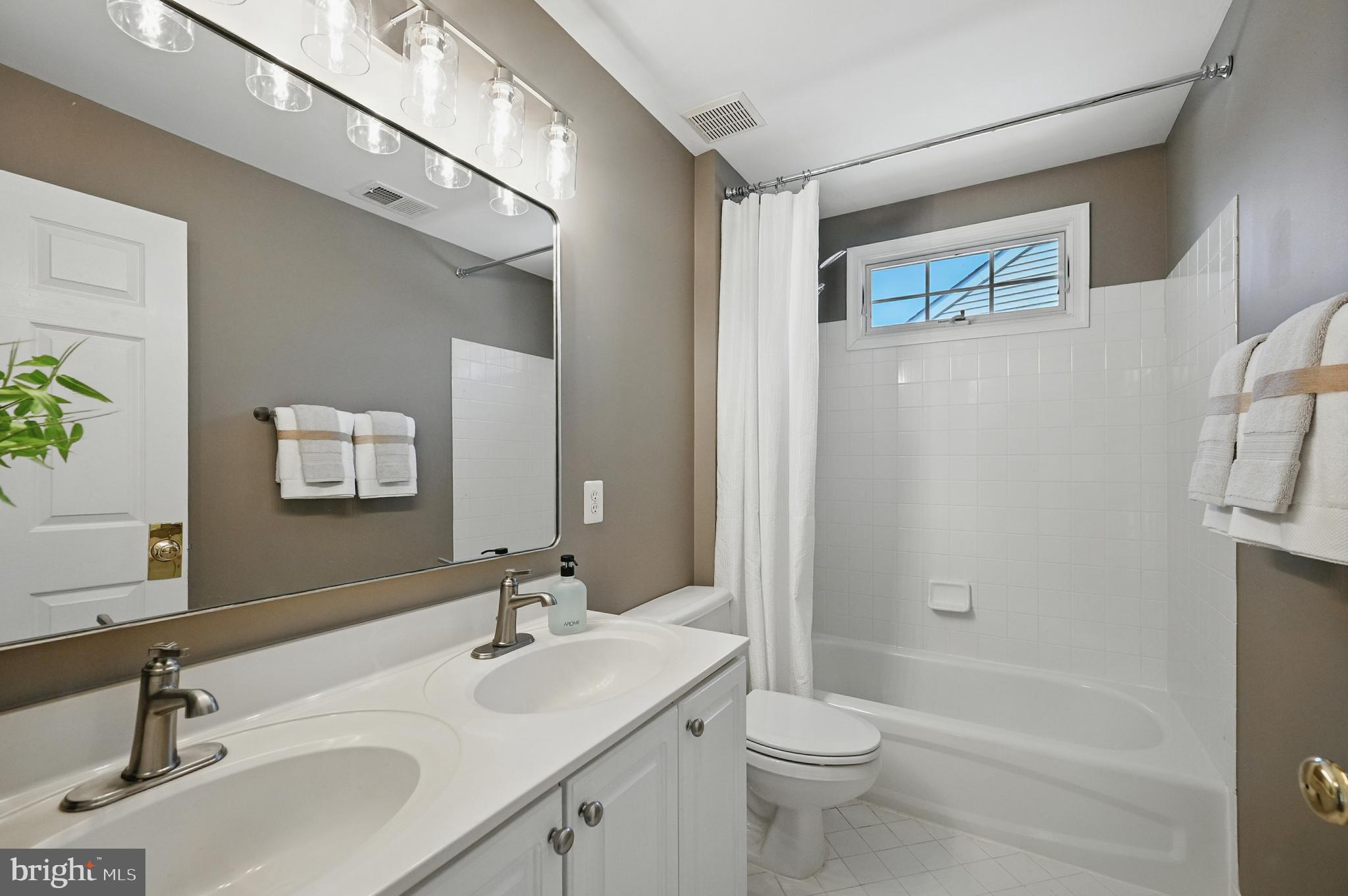 10861 Hunter Gate Way Reston, VA 20194 - Photo 43 of 79 a bathroom with a sink a toilet and shower