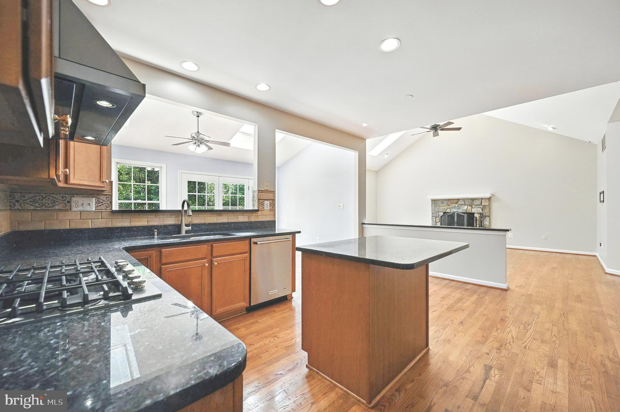 10861 Hunter Gate Way Reston, VA 20194 - Photo 10 of 79 a kitchen with stainless steel appliances granite countertop a sink stove and refrigerator