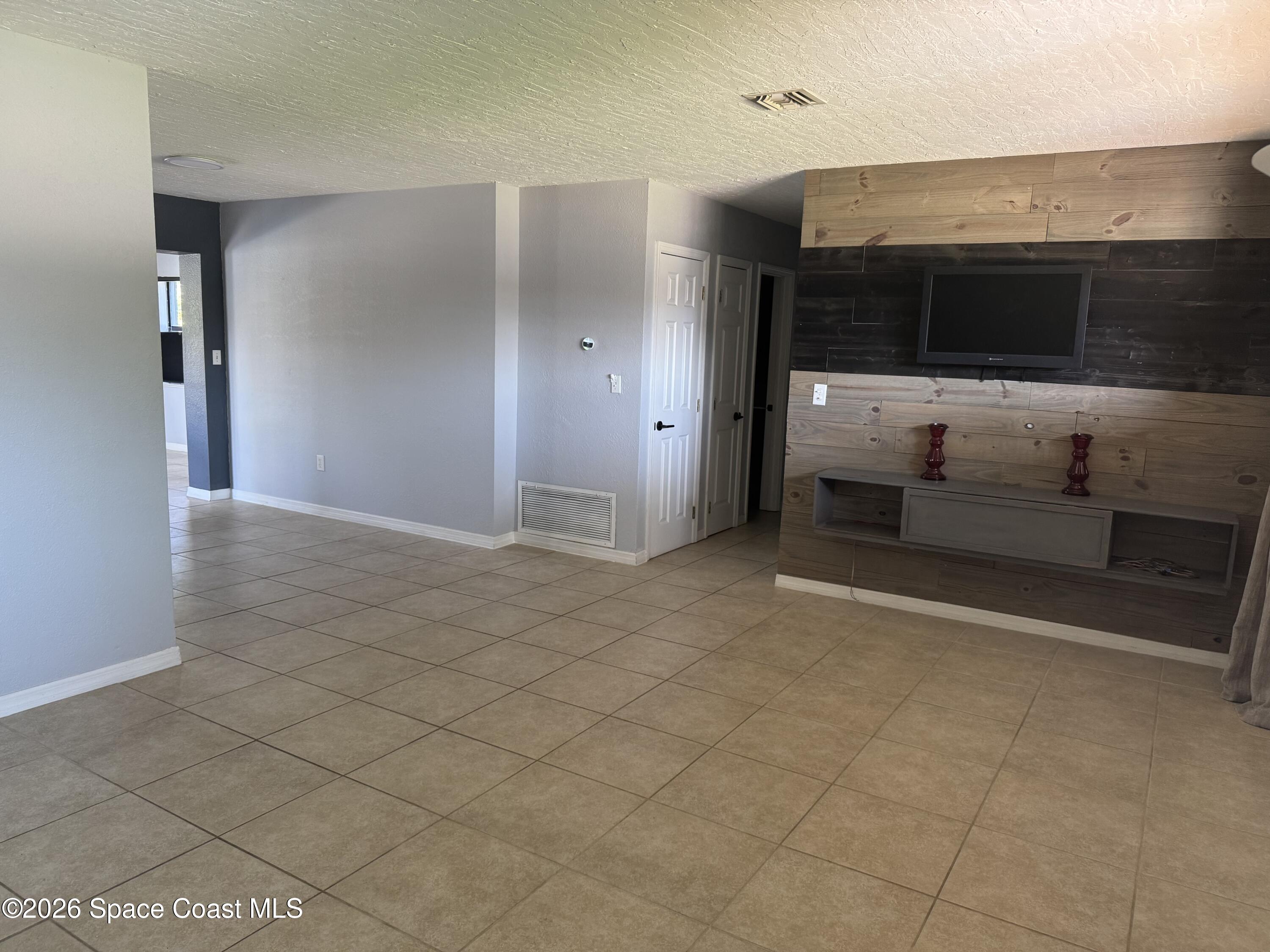 2135 South River Road Melbourne Beach, FL 32951 - Photo 2 of 14 a view of living room with furniture and flat screen tv