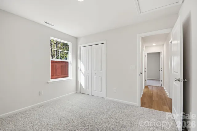 an empty room with windows and closet