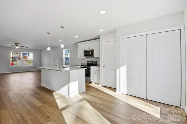 a view of kitchen with cabinets and wooden floor
