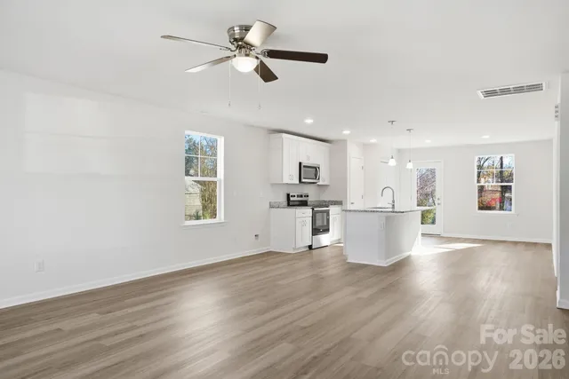 a view of a kitchen with wooden floor and a kitchen
