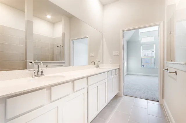 a bathroom with double sink and a mirror