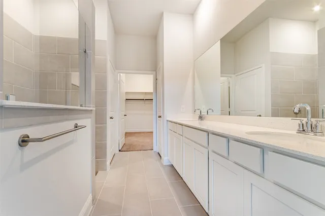 a bathroom with a double vanity sink and mirror