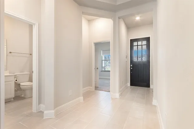 a view of a bathroom from a hallway