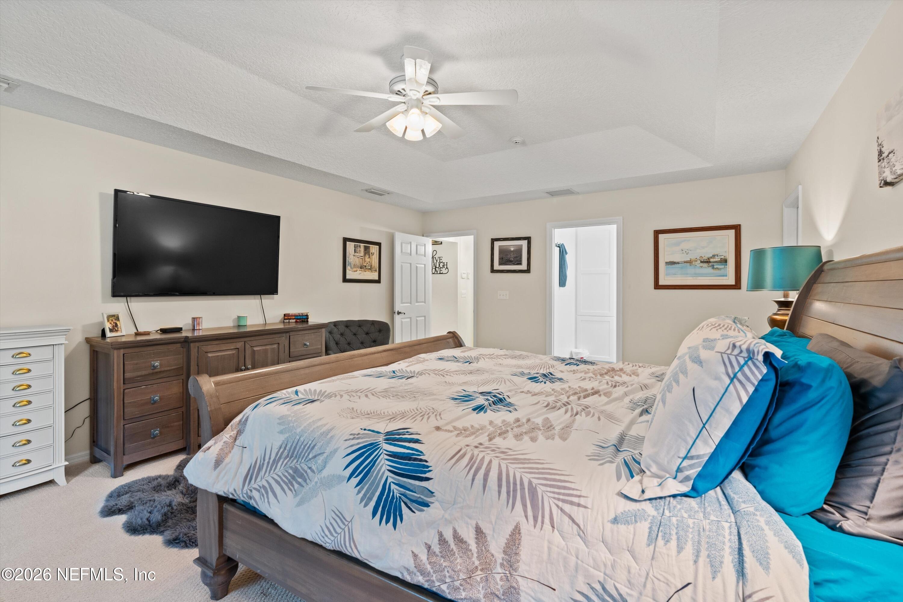 5566 Don Manuel Road Elkton, FL 32033 - Photo 19 of 47 a spacious bedroom with a bed and a flat screen tv
