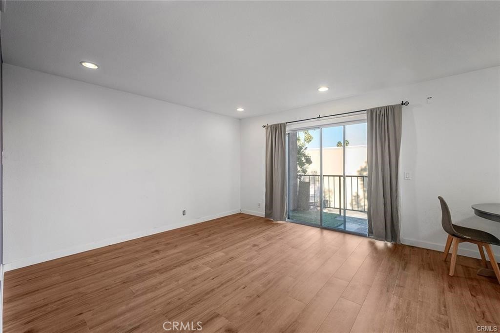17034 Colima Road, Unit 126 Hacienda Heights, CA 91745 - Photo 3 of 24 a view of an empty room with wooden floor and a window
