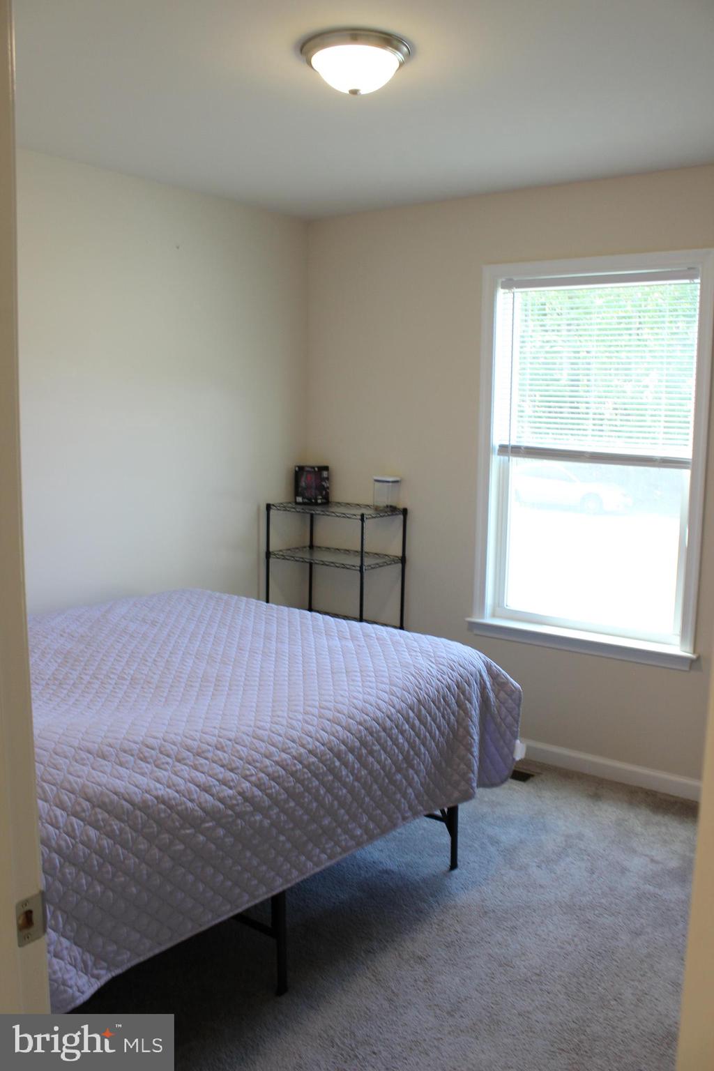 48 Rustic Lane Colonial Beach, VA 22443 - Photo 16 of 29 a bedroom with a bed and window
