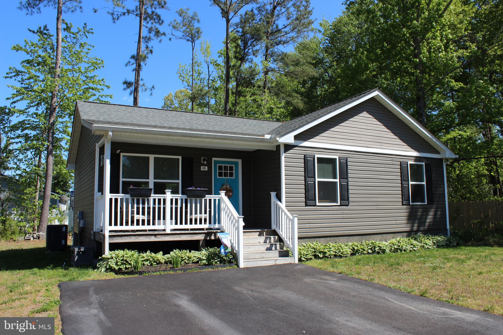 48 Rustic Lane Colonial Beach, VA 22443 - Photo 2 of 29 a front view of a house with a garden