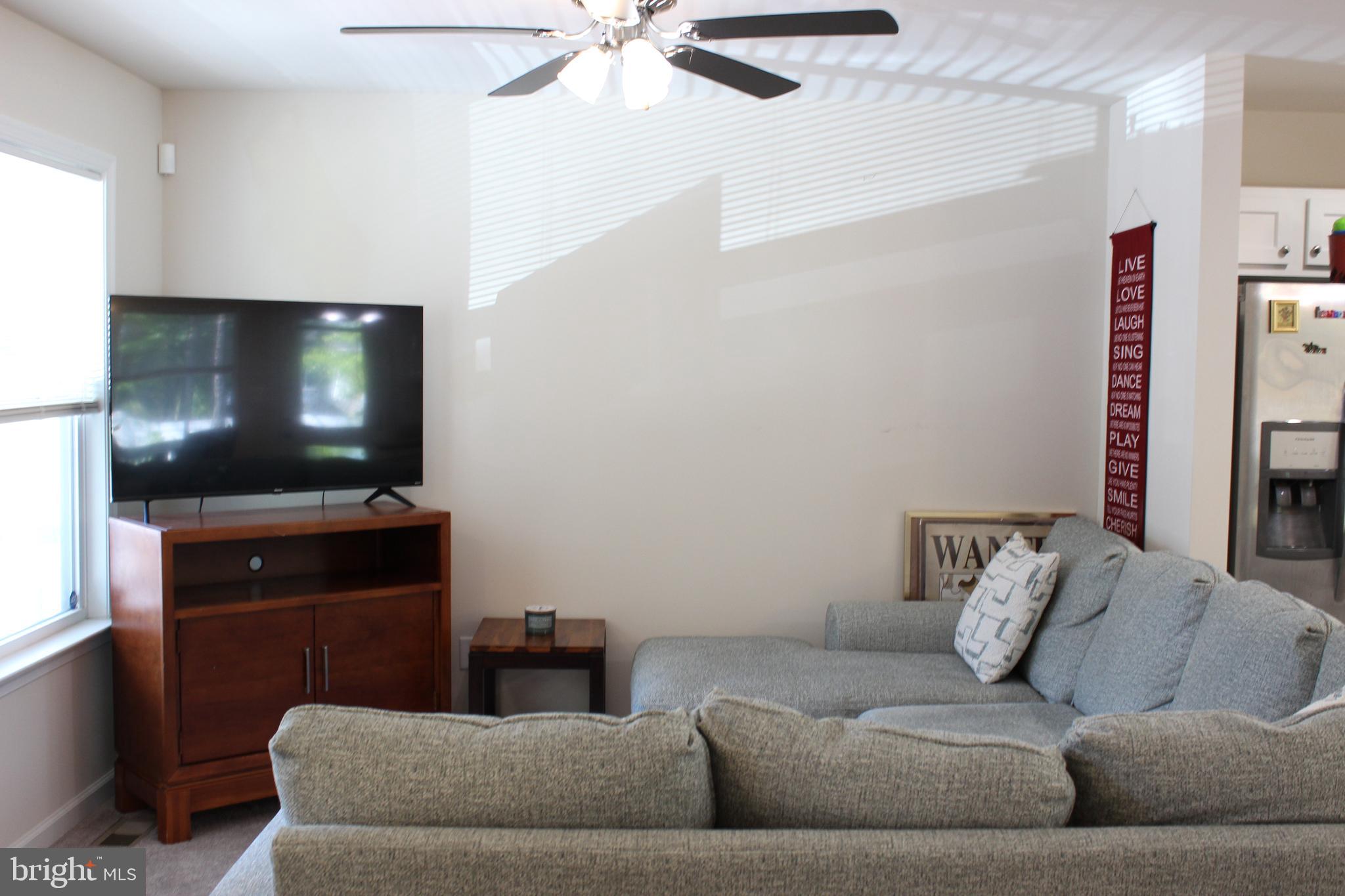 48 Rustic Lane Colonial Beach, VA 22443 - Photo 24 of 29 a living room with furniture and a flat screen tv
