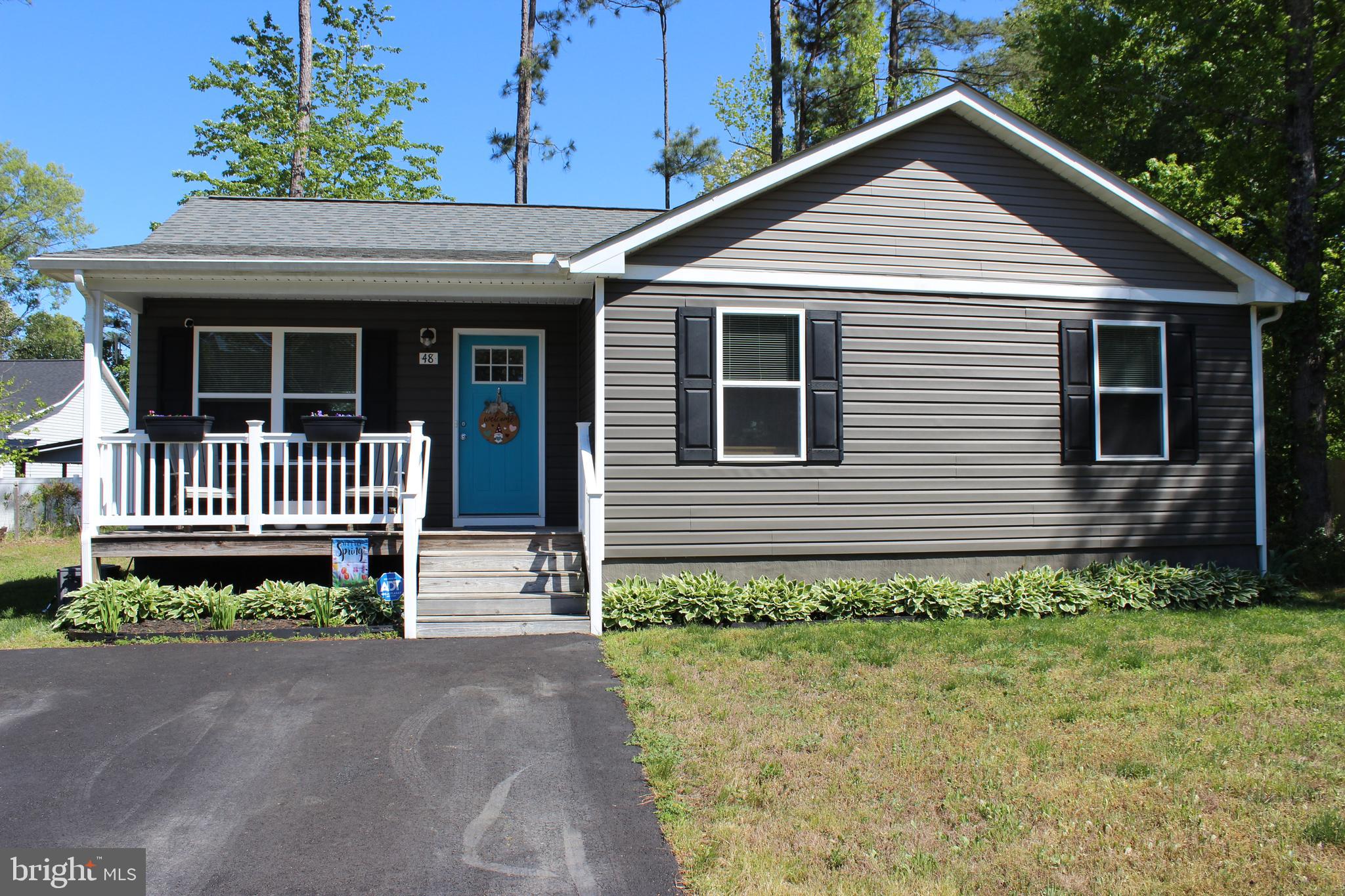 48 Rustic Lane Colonial Beach, VA 22443 - Photo 3 of 29 a front view of a house with a yard