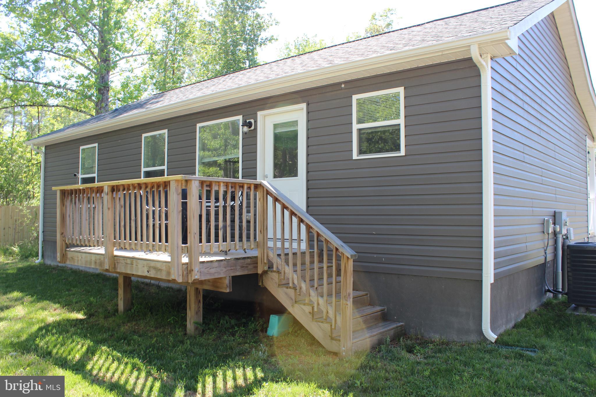 48 Rustic Lane Colonial Beach, VA 22443 - Photo 4 of 29 a view of a house with backyard and deck