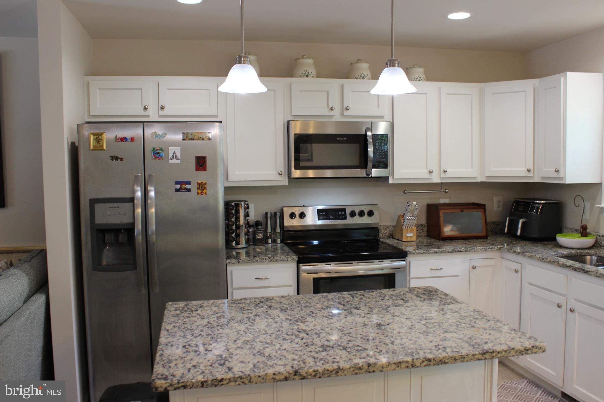 48 Rustic Lane Colonial Beach, VA 22443 - Photo 5 of 29 a kitchen with stainless steel appliances granite countertop a refrigerator a stove and a sink