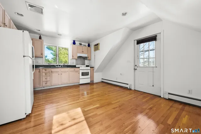 a view of a kitchen with a sink and a refrigerator