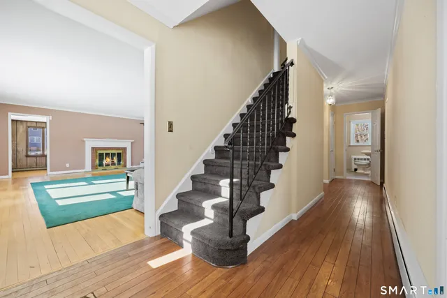 a view of entryway and hall with wooden floor