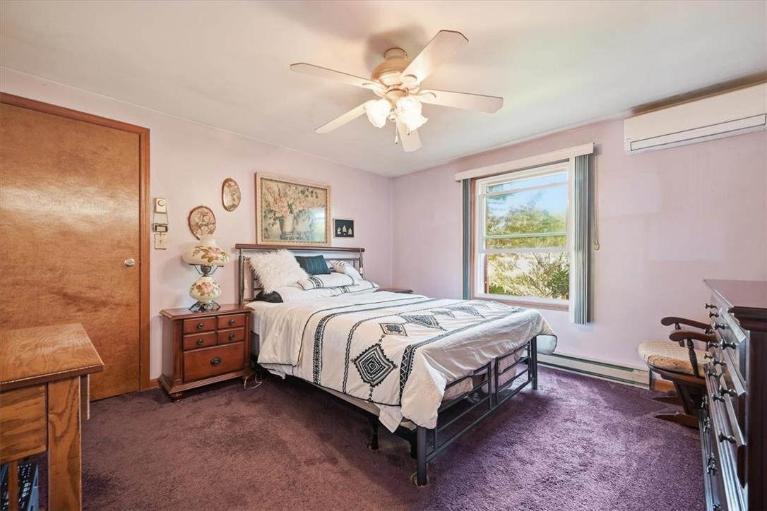74 Swiss View Road Lehighton, PA 18235 - Photo 34 of 59 Richly carpeted bedroom features a wide window framing lush outdoor greenery views.