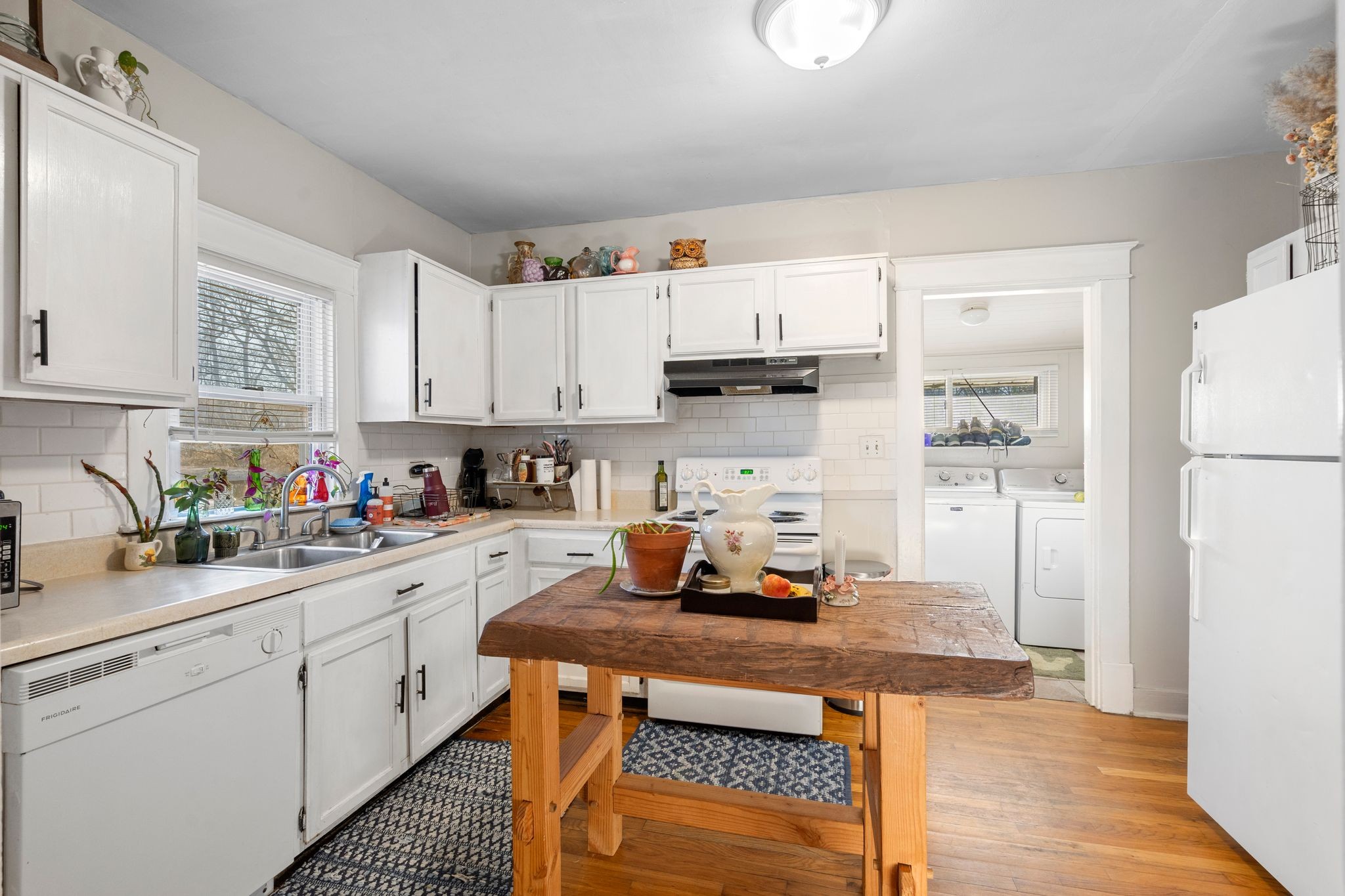 1712 County Hospital Road Nashville, TN 37218 - Photo 11 of 31 a kitchen with a sink a stove and white cabinets