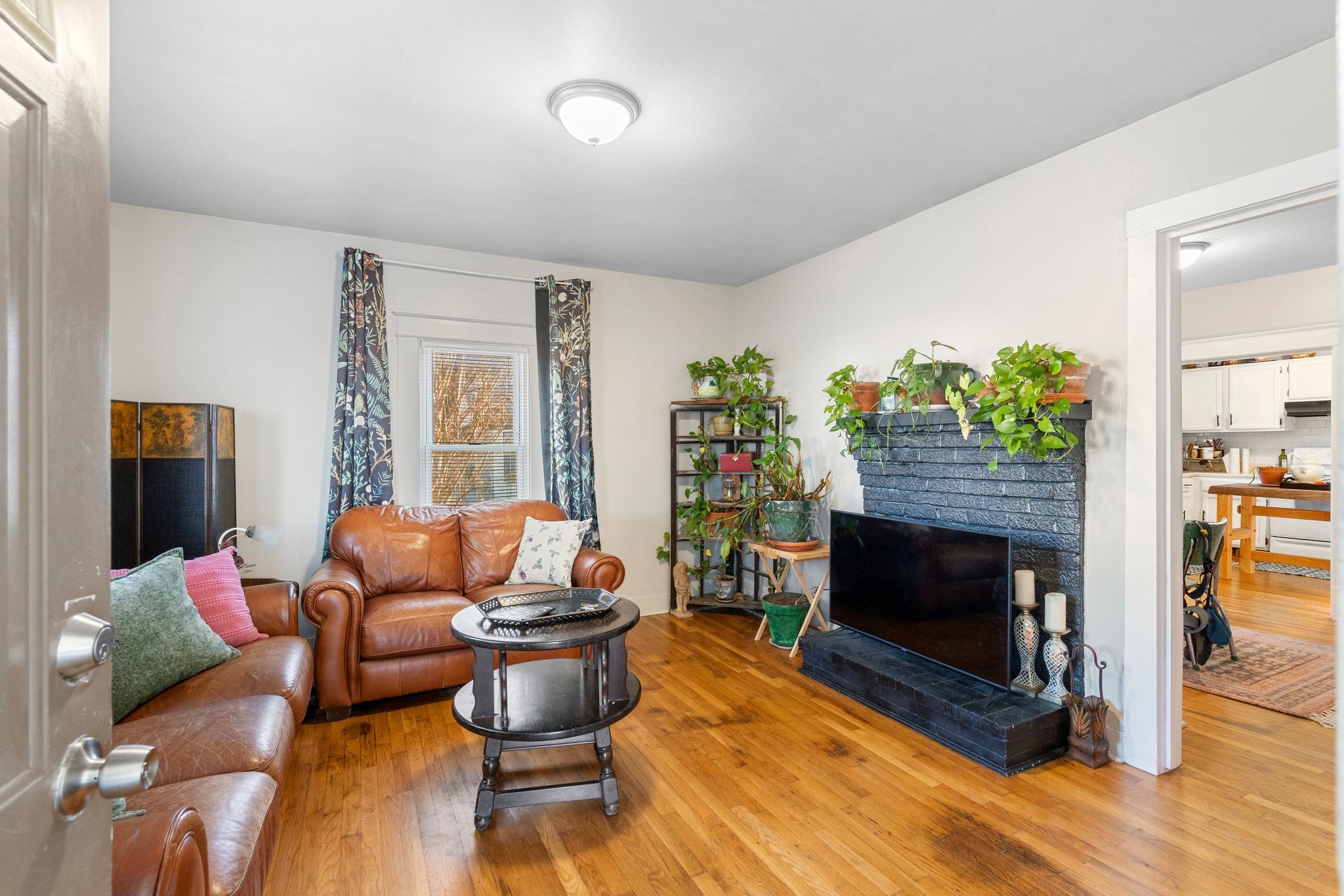 1712 County Hospital Road Nashville, TN 37218 - Photo 4 of 31 a living room with furniture a fireplace and a potted plant