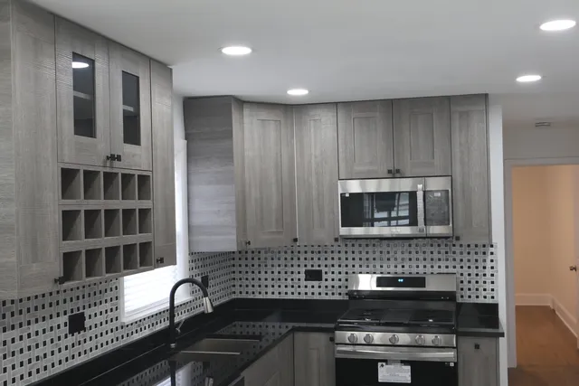 a kitchen with a stove a sink and a microwave