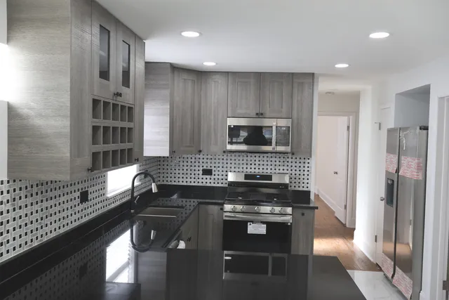 a kitchen with cabinets and a stove top oven
