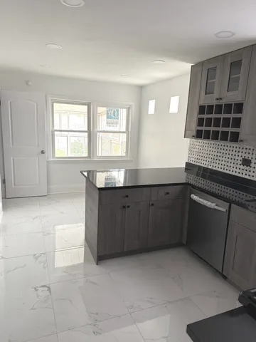 a kitchen with granite countertop a sink and cabinets