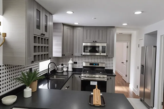 a kitchen with sink refrigerator and stove