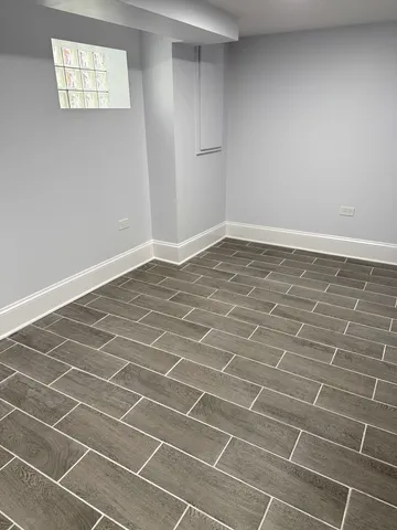 a view of a room with wooden floor and a window