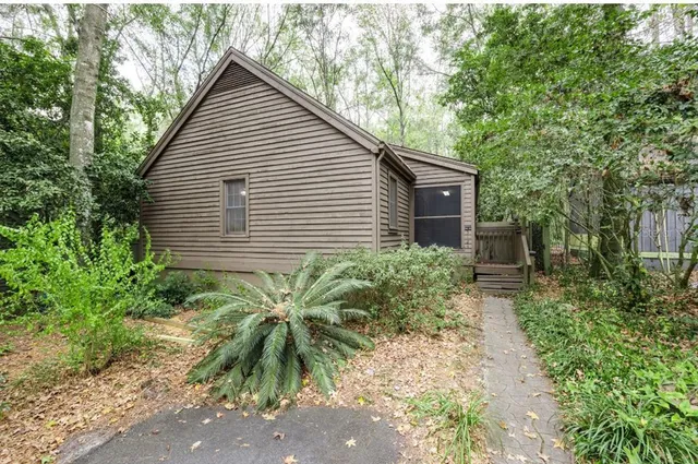 a backyard of a house with a garden and plants