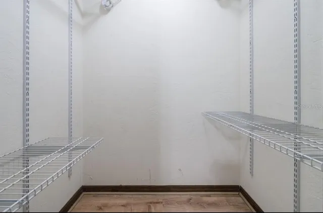 a view of storage and utility room with window