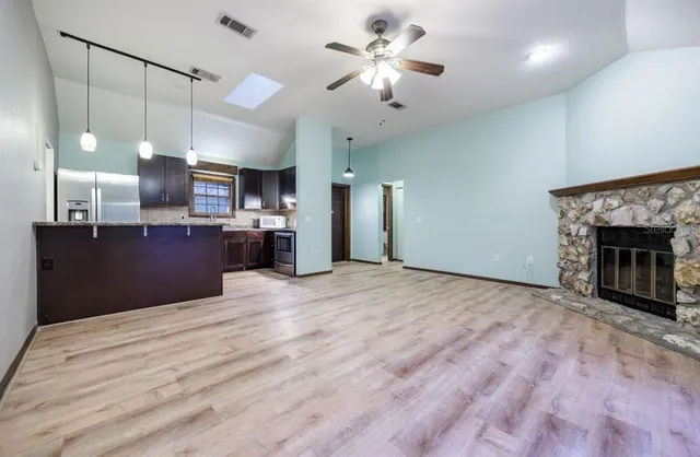 a view of a kitchen with a sink and a fireplace