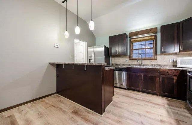 a kitchen with a sink and cabinets