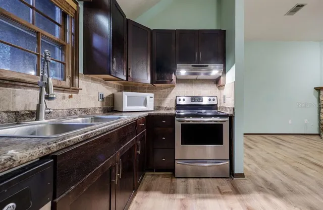 a kitchen with a stove and a sink