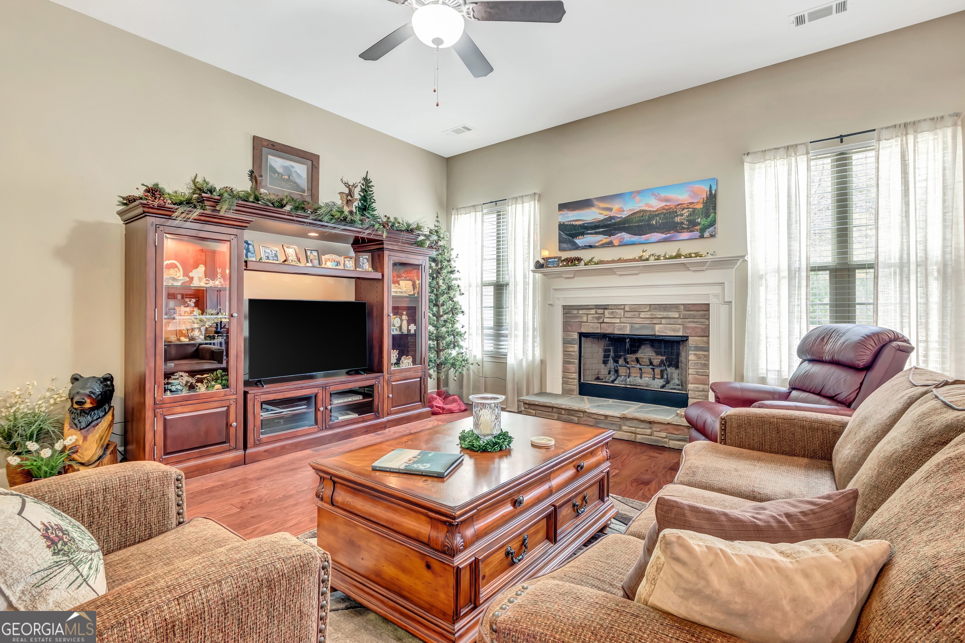 32 Austin Storey Circle Newnan, GA 30263 - Photo 36 of 84 a living room with furniture a flat screen tv and a fireplace