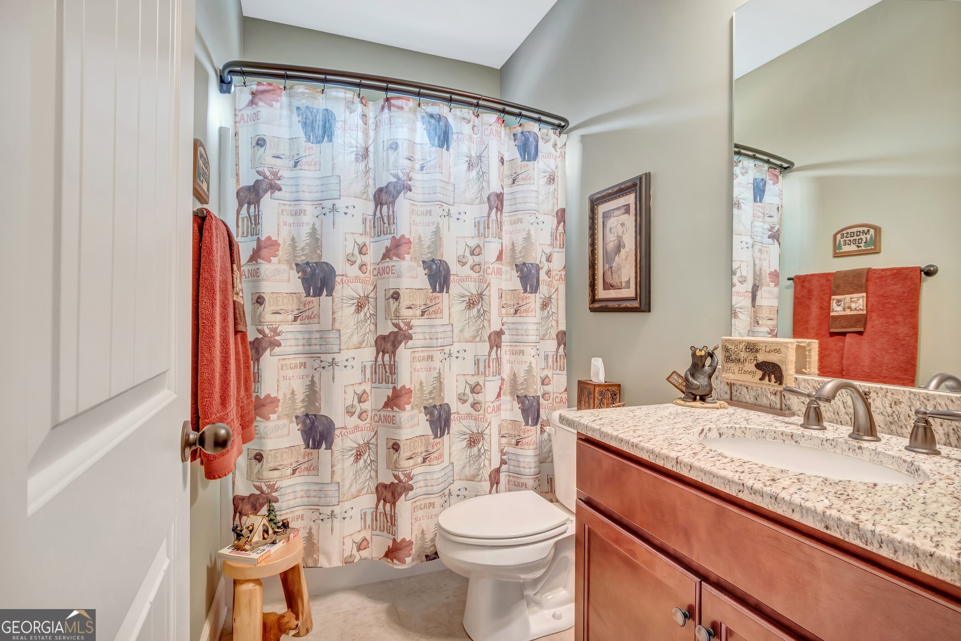 32 Austin Storey Circle Newnan, GA 30263 - Photo 41 of 84 a bathroom with a granite countertop sink a toilet and a mirror