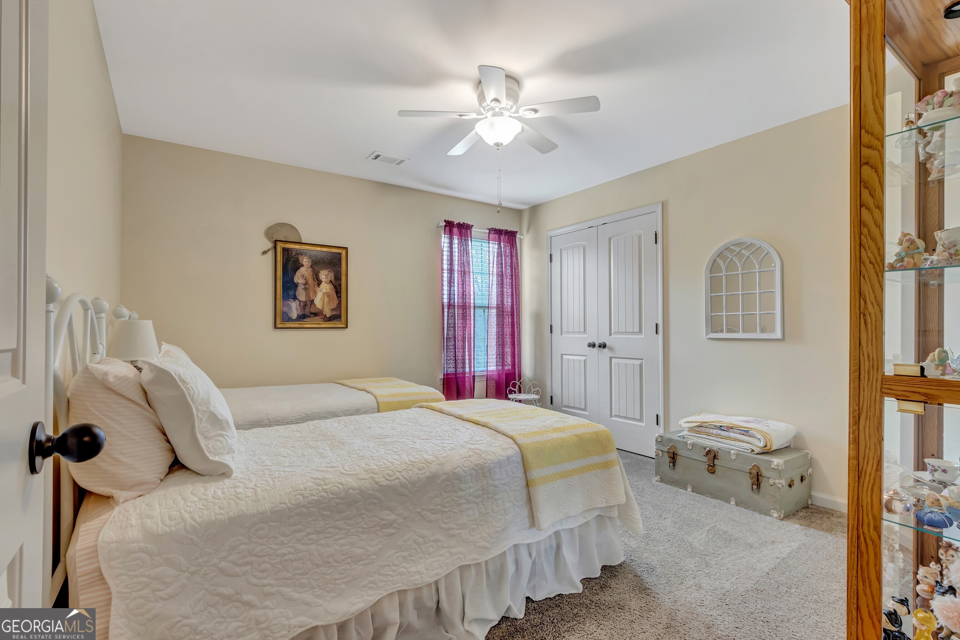 32 Austin Storey Circle Newnan, GA 30263 - Photo 55 of 84 a bedroom with a large bed and a chandelier