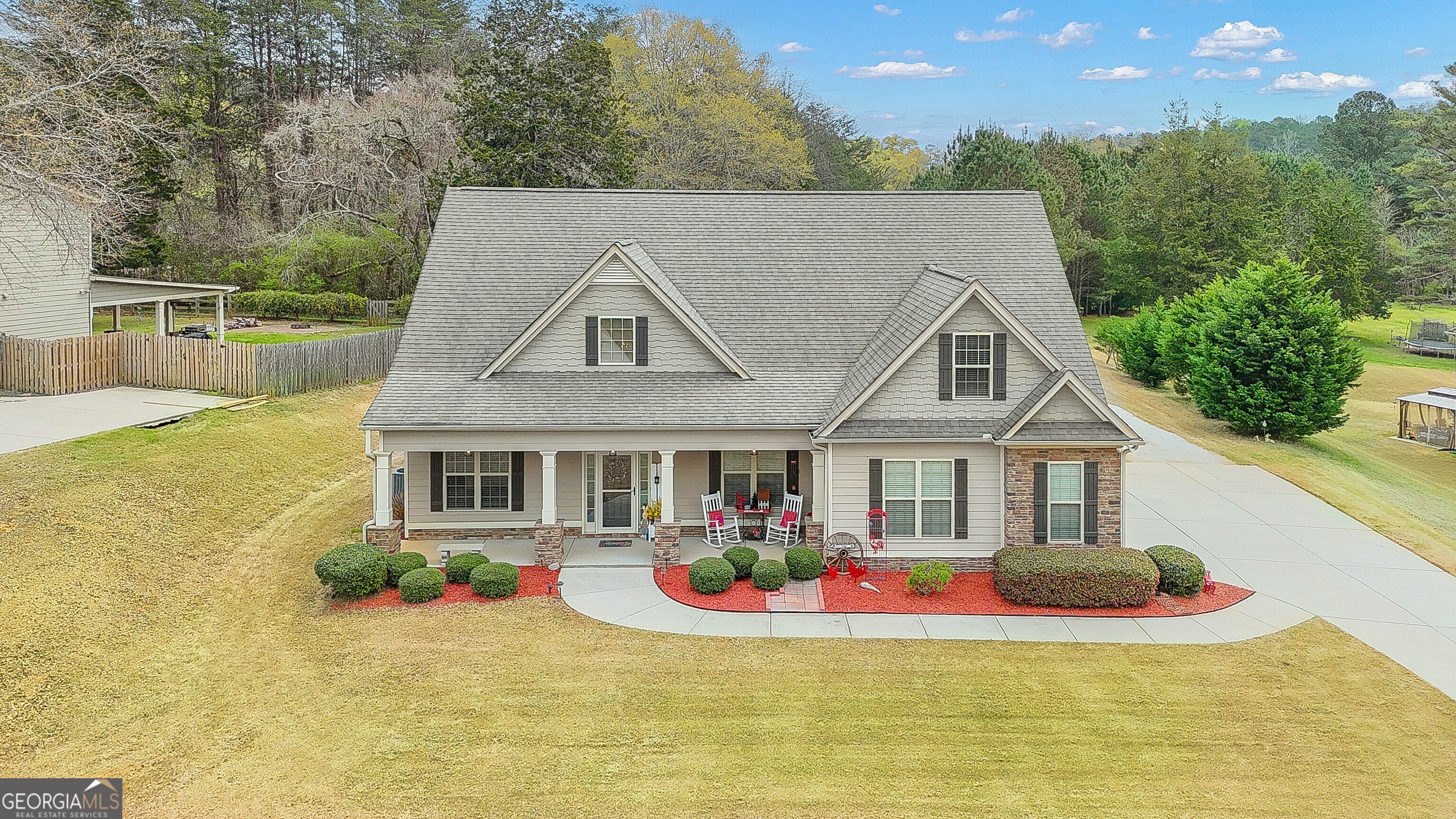 32 Austin Storey Circle Newnan, GA 30263 - Photo 83 of 84 a view of a white house with a big yard and potted plants
