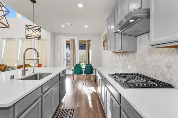a kitchen that has a sink and a stove