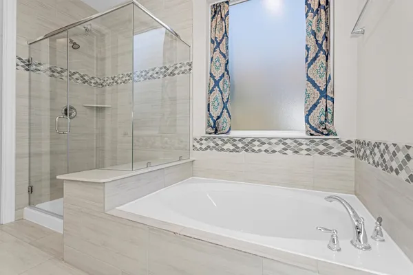 a bathroom with a bathtub and shower