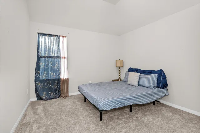 an empty room with closet and mirror