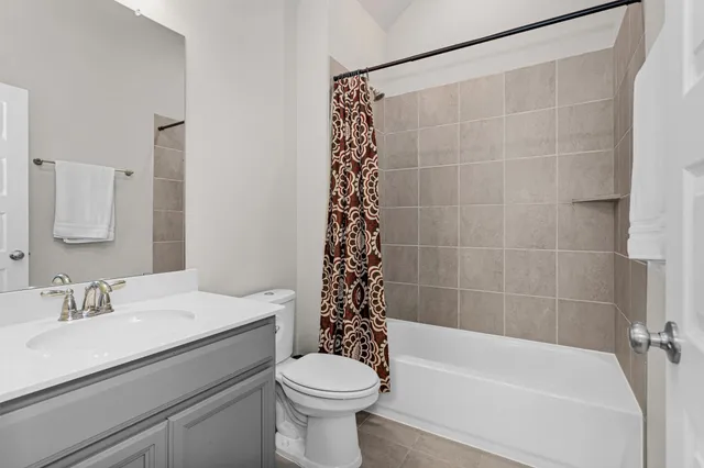 a bathroom with a granite countertop sink a toilet and a mirror