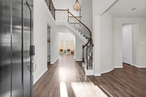 a view of hallway with wooden floor