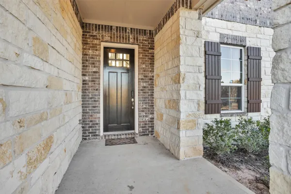 a view of a brick house with a large window