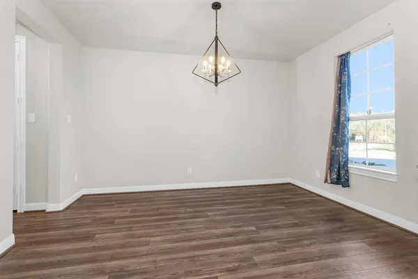 a view of a room with wooden floor and window